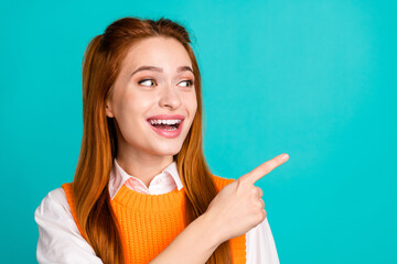Photo portrait of pretty young girl point look shocked empty space wear trendy orange knitwear...
