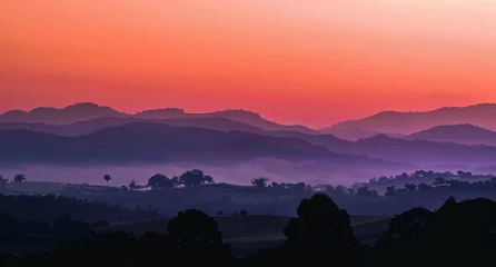 Fototapeten Panoramic rural sunset, with layers of hills fading into the distance under a sky ablaze with colors, providing a moment of awe and reflection on the day's end. © radekcho