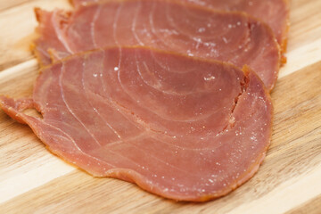 thin slices of Smoked tuna macro food background - 770024433
