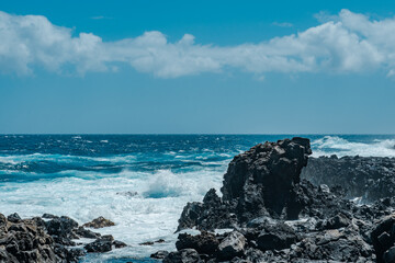Makapuʻu Tide Pools, basalt comes from the Koʻolau volcano in eastern Oahu, Hawaii Geology. Waves hitting the rocks. 
