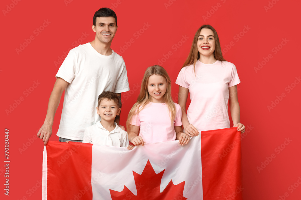 Wall mural happy family with flag of canada on red background