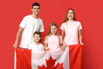Happy family with flag of Canada on red background - obrazy, fototapety, plakaty