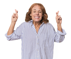 Redhead mid-aged Caucasian woman in studio crossing fingers for having luck