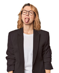Caucasian woman in black business suit funny and friendly sticking out tongue.