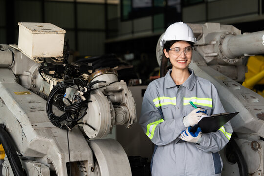 Professional engineering, worker, woman Quality control, maintenance, check in factory, Workshop for factory operators, Robotics engineer Female worker in a modern automotive manufacturing plant.