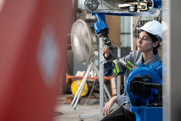 Professional engineering, worker, woman Quality control, maintenance, check in factory, Workshop for factory operators, Robotics engineer Female worker in a modern automotive manufacturing plant.