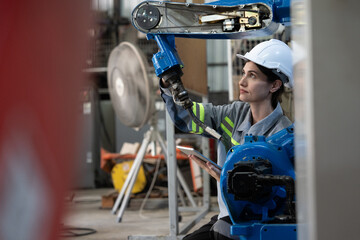 Professional engineering, worker, woman Quality control, maintenance, check in factory, Workshop for factory operators, Robotics engineer Female worker in a modern automotive manufacturing plant.