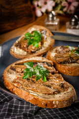 Slices of multigrain bread with sprats.