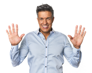 Middle-aged Latino man showing number ten with hands.