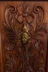 Close-up -pattern of flowers carved on wood, old wood carving
