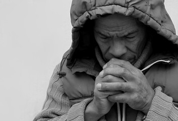 man praying to god with hands together Caribbean man praying with grey background stock image stock...