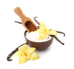 Bowl of vanilla powder with sticks and flowers on white background