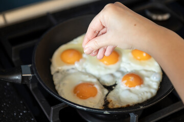 Close-up shot of a woman preparing scrambled eggs for breakfast