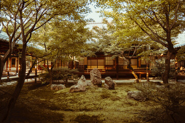 Tranquil Japanese garden with stone setting amidst vibrant foliage.