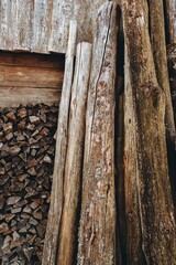 Wooden texture. Chopped firewood pile stacked under the roof. Dried old logs and blocks. Woodpile...