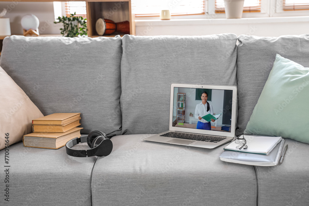 Sticker Screen of laptop with teacher giving online lesson on sofa in room