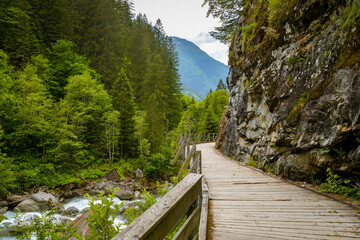 Walking trail near Charstelenbach stream in Maderanertal valley in Switzerland
