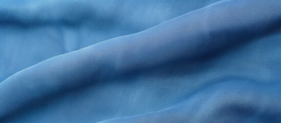 Obraz premium A close up of electric blue fabric resembling the sky with cumulus clouds, capturing the essence of a meteorological phenomenon in macro photography