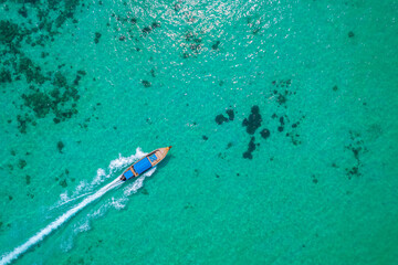 Aerial top view thai long tail boat move with tourists in turquoise water sea, Phi Phi Island....
