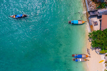 Aerial top view thai long tail boat parking on white beach in turquoise sea. Phi Phi Island,...