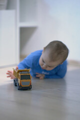 Baby Playing With Toy Truck on the Floor