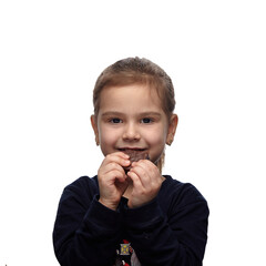 Cute little girl with a chocolate candy in her hands, eating and smiling