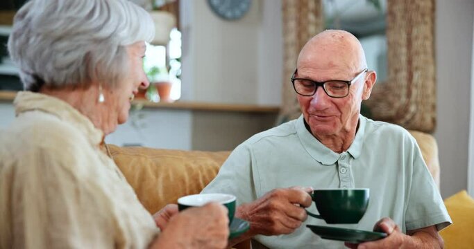Senior, couple and talking with tea in home together in retirement, vacation or relax on calm holiday. Drink, coffee and old people on sofa chat about marriage or communication of news in living room