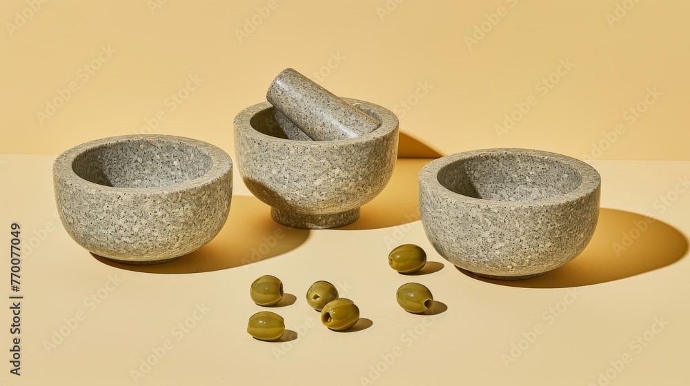 Poster a pair of bowls resting on a table with two olives beside them