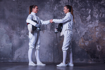 Two women fencing