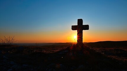 A powerful photograph of a cross silhouetted against a clear blue sky with the morning sun, conveying the significance of the cross in the Christian faith and the promise of redemption - obrazy, fototapety, plakaty
