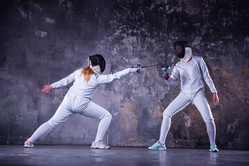 Two women fencing