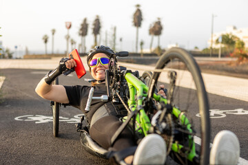 Smiling woman athlete enjoying handbike ride