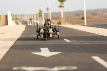 Determined handbike athlete training on road