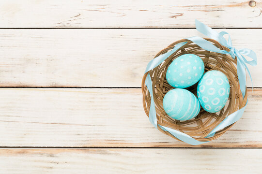 Blue easter eggs on wooden background, top view