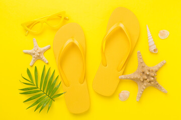 Bright yellow flip-flops on color background, top view. Summer concept