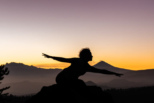 Contemporary dancer silhouetted by a stunning sunset