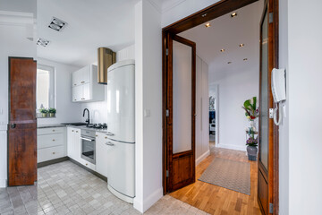 Fototapeta na wymiar Modern kitchen and corridor with wooden finishing