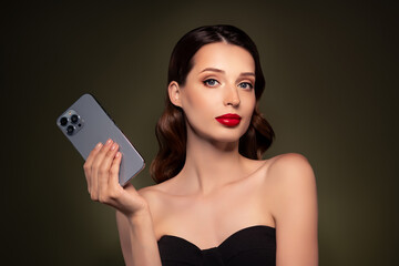 Portrait of stunning beautiful elegant rich lady popular blogger holding phone advertising apple...