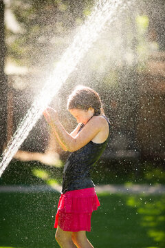 Young kid playing in the water during summer