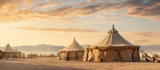 Authentic Bedouin-style tents placed within the desert's heat - obrazy, fototapety, plakaty