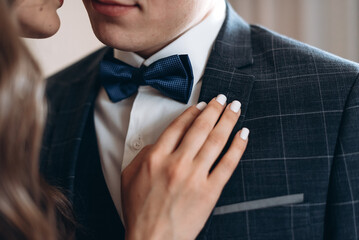 bride holds hand on groom chest