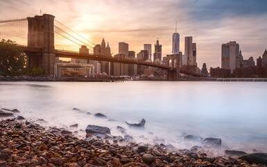 scene of New york Cityscape with Brooklyn Bridge over the east river at the sunset time, USA...