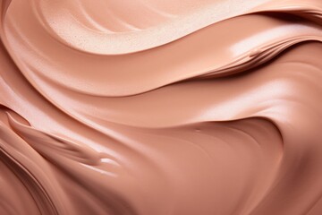 A creamy swatch of makeup is elegantly smeared against a smooth, neutral-toned backdrop. - obrazy, fototapety, plakaty