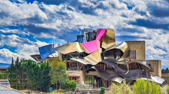Elciego, Alava, Spain; march 28th 2024: Front view of a modern building with wavy aluminum structures designed by the architect Frank O. Gehry, for the Rioja wine cellars called Marques de Riscal