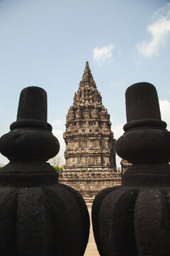 Ancient temple in Indonesia framed between silhouettes