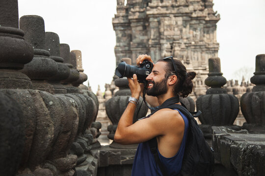 Man capturing memories at an Indonesian temple
