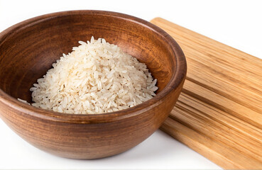 Fototapeta na wymiar Roasted rice in wood bowl, cut out on white background