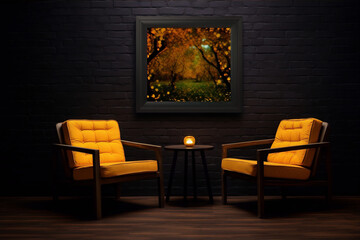 Two orange armchairs in a dark brick room with a framed painting of an autumn forest on the wall behind them and a small round table with a candle between them.