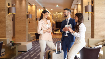 Group of business people arriving in a hotel for a business conference