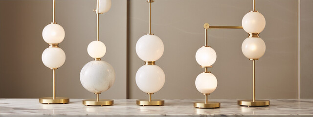 Elegant minimalist table lamps with round frosted glass shades and golden rods on marble table against beige background in interior design